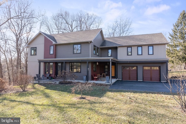 view of front of house featuring a front lawn, an attached garage, driveway, and a shingled roof