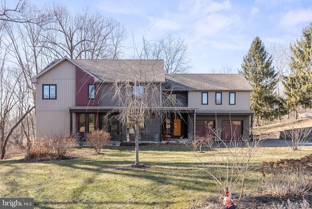 view of front of property with an attached garage, a porch, a front lawn, and a shingled roof