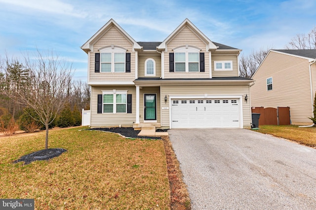 view of front facade featuring aphalt driveway, a garage, fence, and a front yard