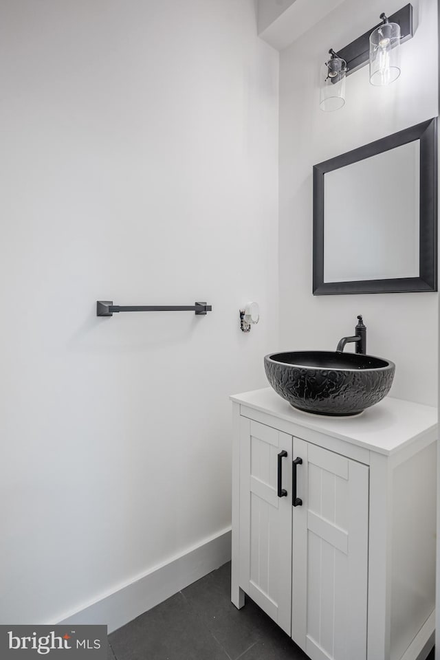 bathroom featuring tile patterned flooring, vanity, and baseboards