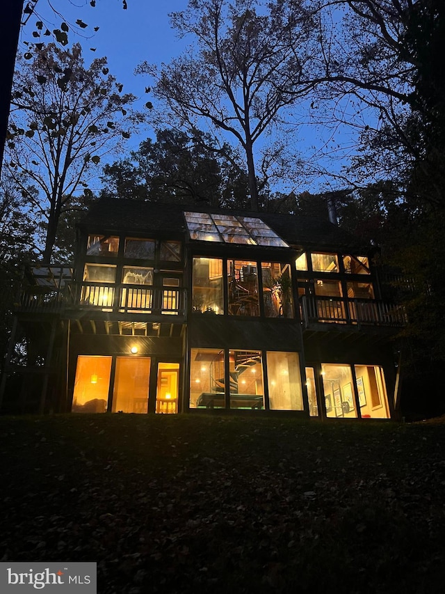 view of back house at twilight