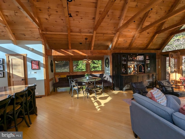 living room with a healthy amount of sunlight, wooden ceiling, lofted ceiling with beams, and light hardwood / wood-style flooring