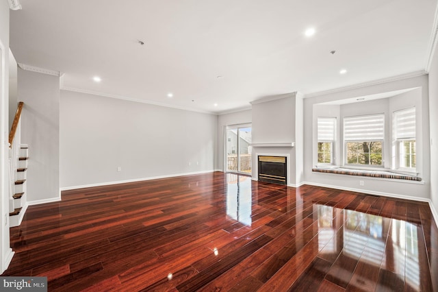 unfurnished living room featuring dark hardwood / wood-style flooring and ornamental molding