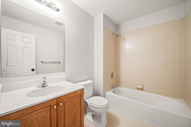 full bathroom with tiled shower / bath, vanity, toilet, and tile patterned flooring