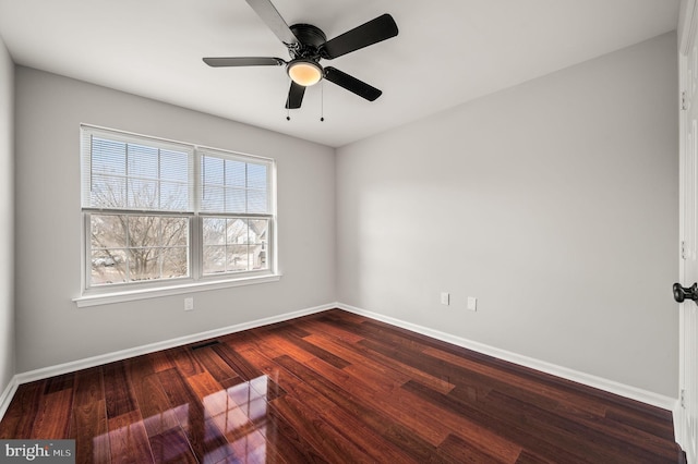 spare room featuring dark hardwood / wood-style floors and ceiling fan