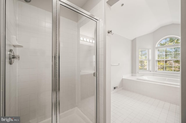 bathroom with vaulted ceiling, tile patterned floors, and separate shower and tub