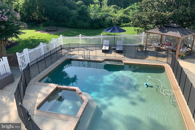 view of swimming pool with a gazebo, fence, a pool with connected hot tub, and a patio area