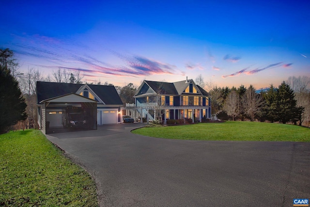 view of front of property featuring a garage and a lawn