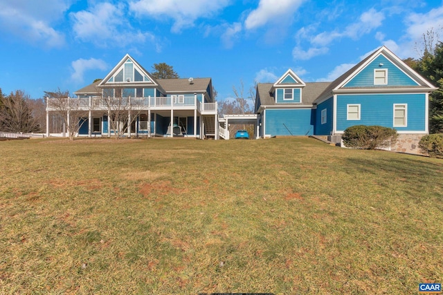 view of front of home with a wooden deck and a front lawn