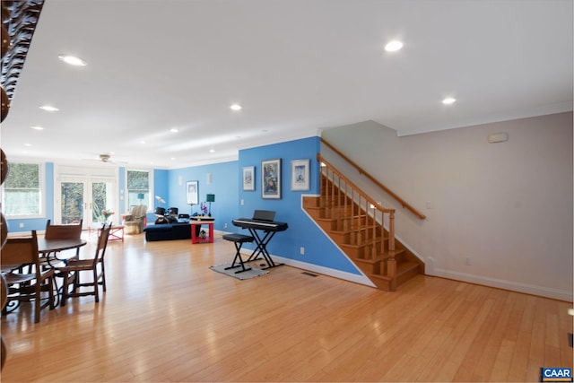 interior space with ceiling fan, ornamental molding, and light hardwood / wood-style flooring