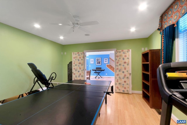 recreation room featuring ceiling fan and light hardwood / wood-style floors