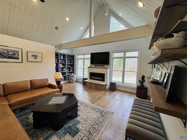 living room featuring high vaulted ceiling, hardwood / wood-style flooring, wooden ceiling, and ceiling fan