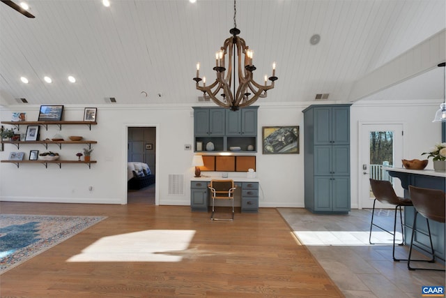 interior space featuring lofted ceiling, a chandelier, wood ceiling, light hardwood / wood-style floors, and crown molding