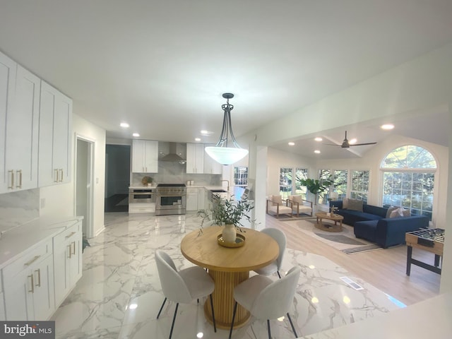 dining space featuring marble finish floor, ceiling fan, and recessed lighting