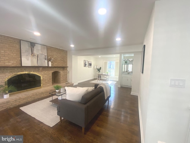 living room with a fireplace, baseboards, dark wood-style flooring, and recessed lighting