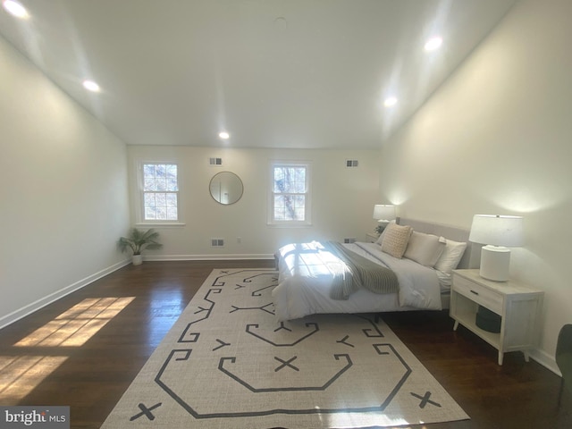 bedroom with dark wood-style floors, baseboards, visible vents, and recessed lighting