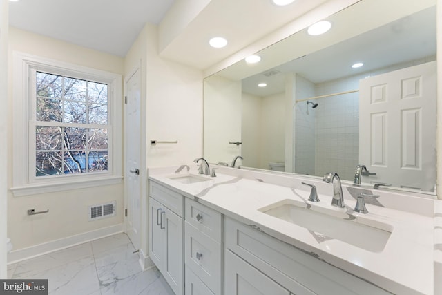 full bath with toilet, baseboards, visible vents, and a sink