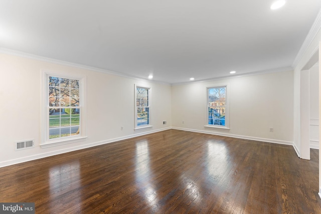 unfurnished room with baseboards, crown molding, visible vents, and dark wood-type flooring