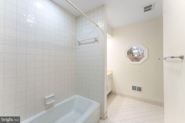 bathroom featuring bathing tub / shower combination, vanity, visible vents, and baseboards