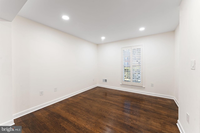 spare room with visible vents, baseboards, dark wood-type flooring, and recessed lighting