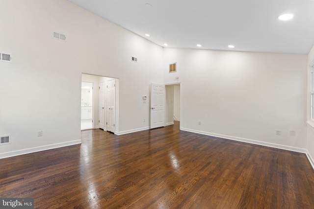 unfurnished living room with dark wood-style flooring and visible vents