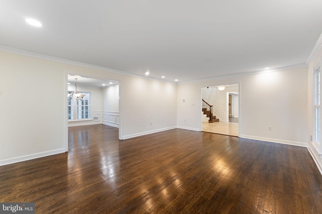 interior space featuring ornamental molding, dark wood finished floors, a notable chandelier, and recessed lighting