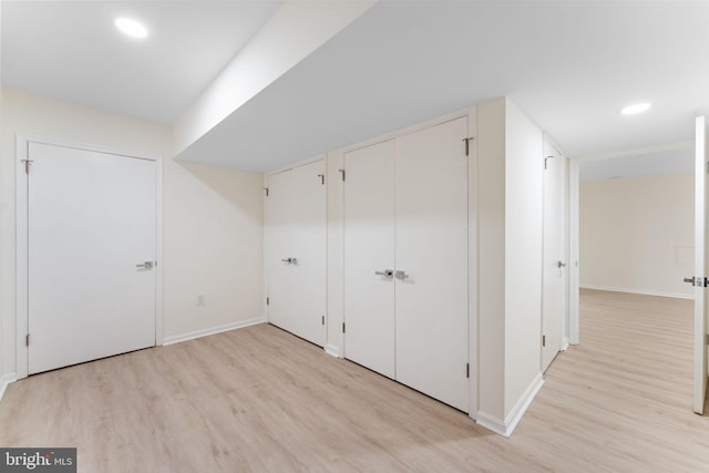 additional living space featuring light wood finished floors, recessed lighting, and baseboards