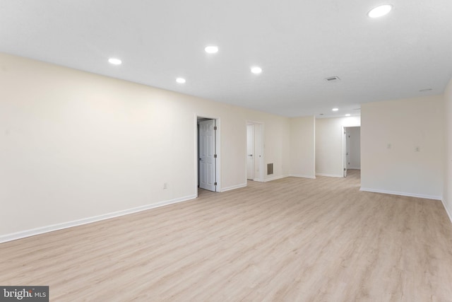 below grade area featuring baseboards, light wood finished floors, visible vents, and recessed lighting