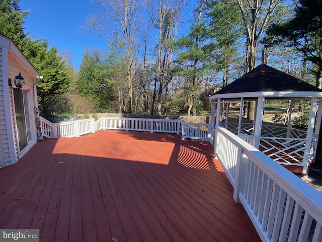 wooden terrace featuring a gazebo