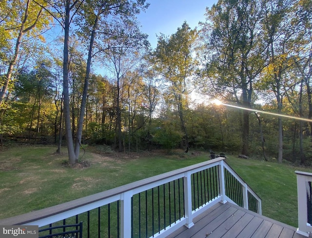 wooden deck with a lawn