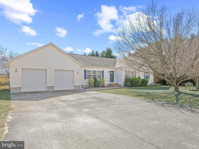 ranch-style home with driveway, a front lawn, and an attached garage