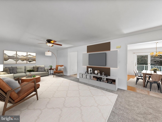 living area with light carpet and ceiling fan with notable chandelier