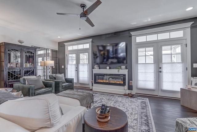 living room with french doors, ceiling fan, and dark hardwood / wood-style floors