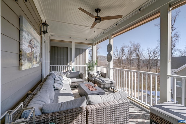 wooden terrace with ceiling fan and an outdoor living space with a fire pit