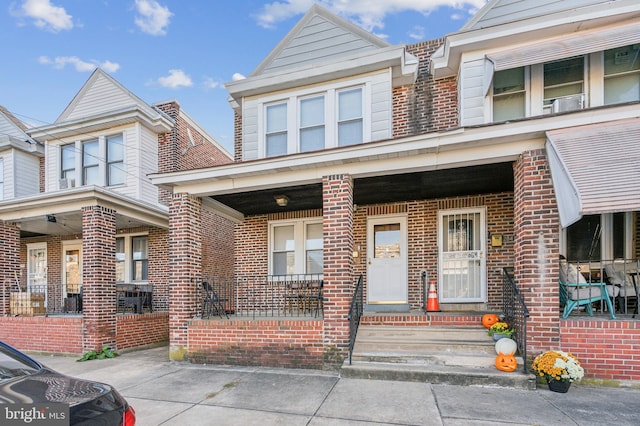 townhome / multi-family property with covered porch