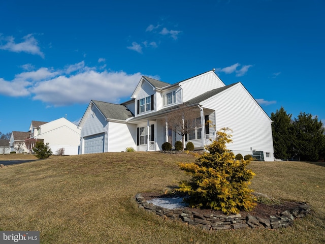 view of front of home with a front lawn and a garage