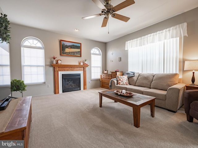 carpeted living room with ceiling fan