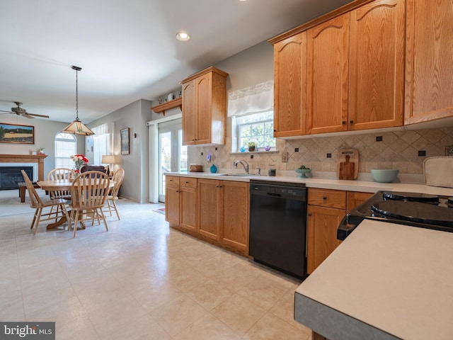 kitchen featuring a wealth of natural light, black dishwasher, decorative backsplash, and pendant lighting