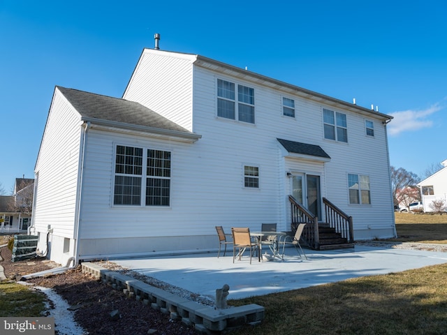 rear view of house with central AC and a patio