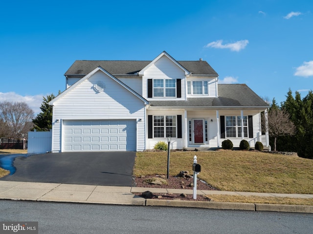 view of front of property featuring a front yard and a garage