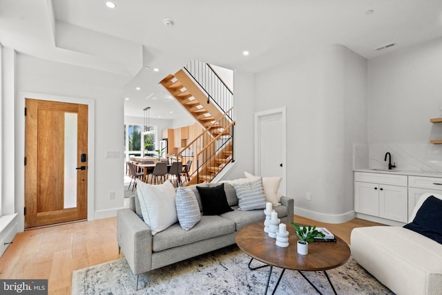 living room with sink and light hardwood / wood-style floors