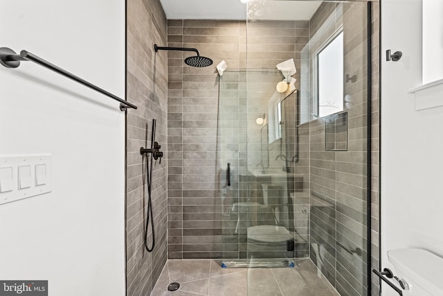 bathroom featuring an enclosed shower and toilet