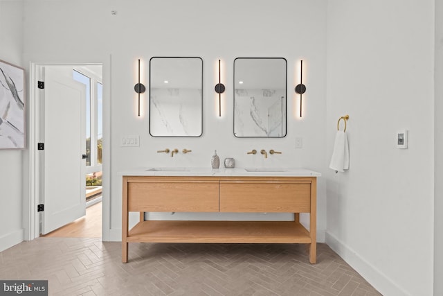 bathroom with vanity and parquet floors