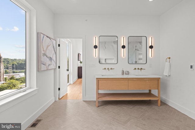 bathroom featuring vanity and parquet flooring