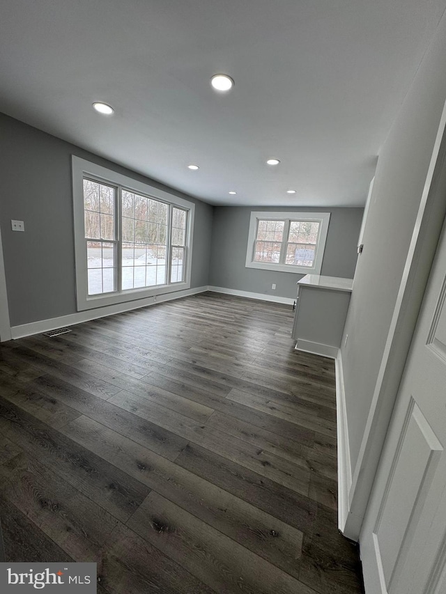 empty room featuring dark hardwood / wood-style flooring