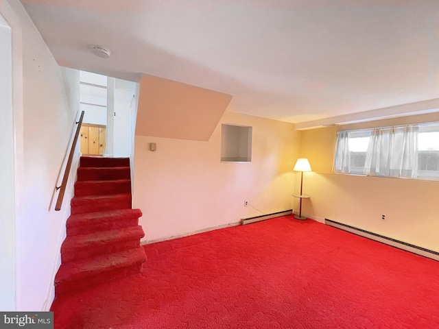 additional living space with carpet and a baseboard heating unit