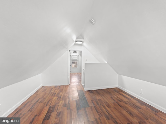 bonus room featuring lofted ceiling and dark hardwood / wood-style floors