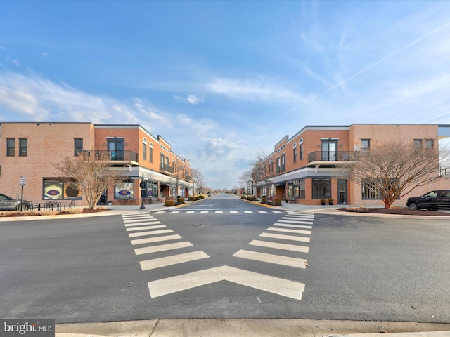 view of road with a residential view, curbs, and sidewalks