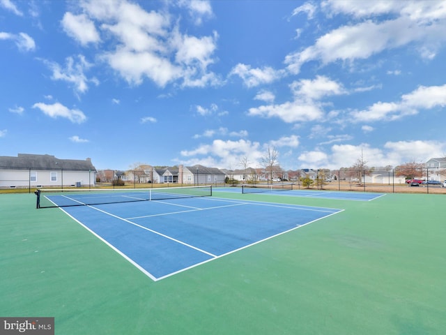 view of sport court featuring a residential view and fence