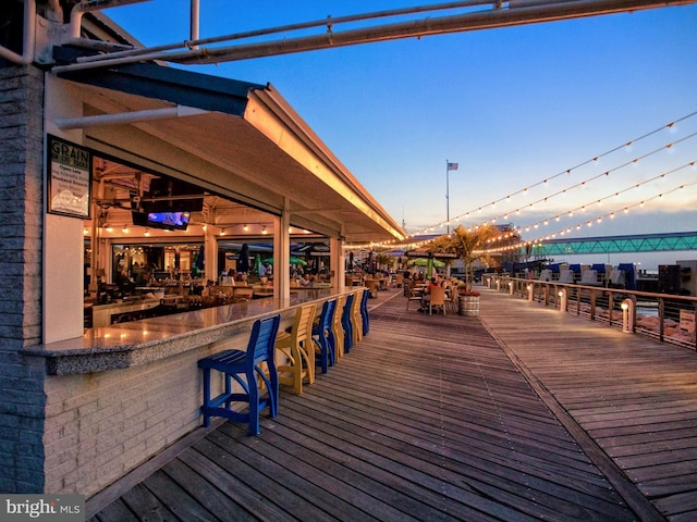 wooden terrace featuring exterior bar